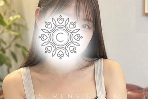 Woman in a beige tank top with a decorative mandala obscuring her face; beauty/spa ad context visible in background.
